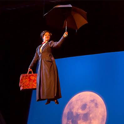  Mary Poppins flying through the air with her umbrella in Festival Place Theatre. 